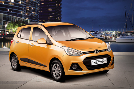 Side front view of tangerine orange Grand i10