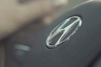 Close-up view of hyundai emblem on steering wheel