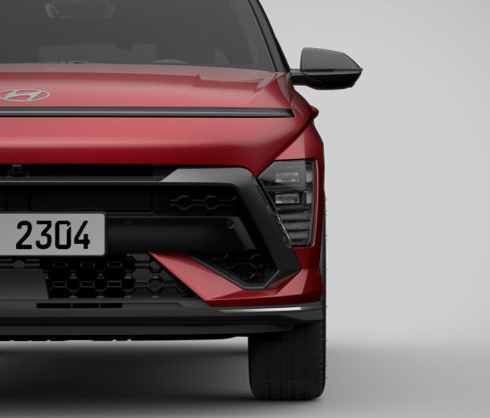 A close-up of the left front bumper of a red The all-new KONA