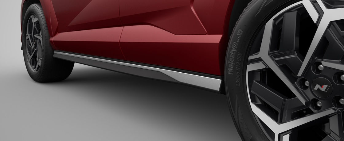 A close-up of ther silver side skirt on the lefe side of the red The all-new KONA