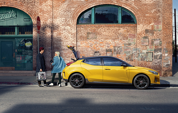 Peoples and side view of yellow veloster parking on the road 