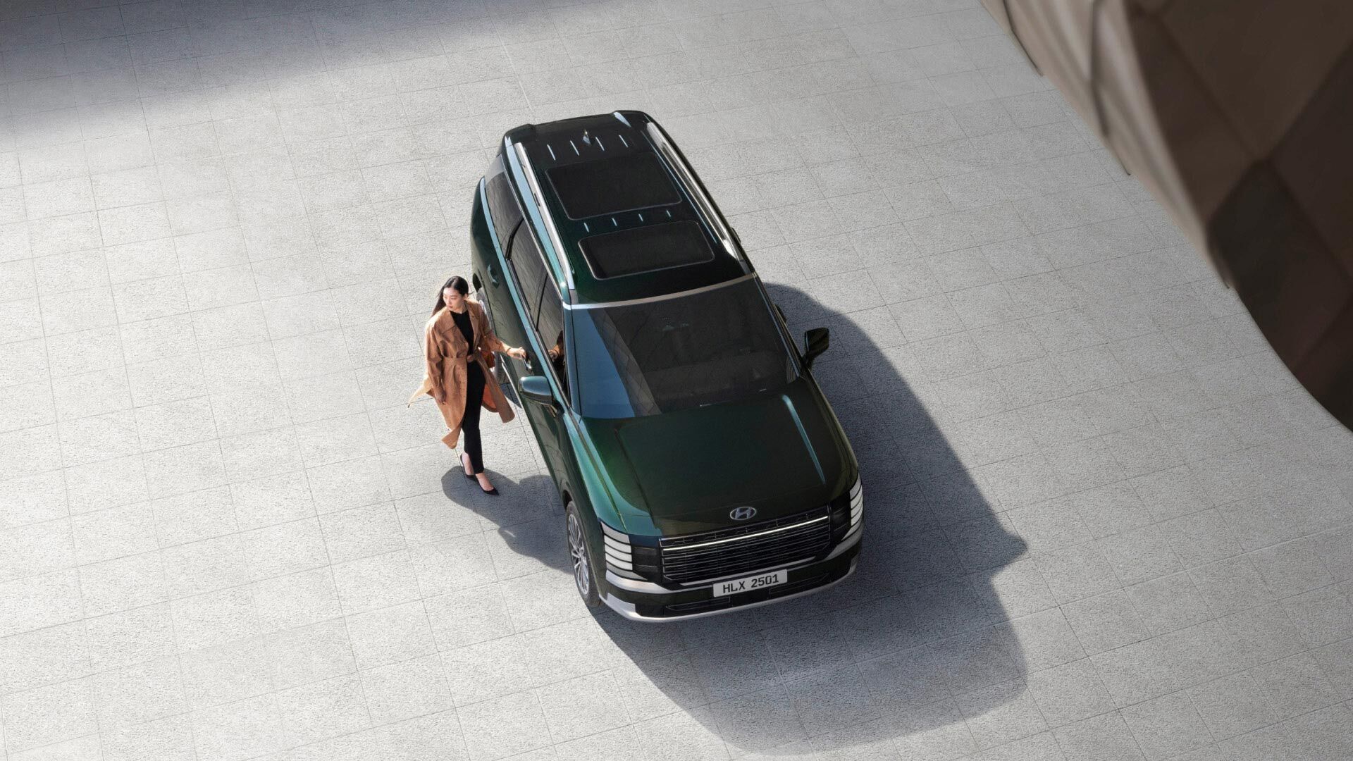 A woman standing next to the all-new PALISADE